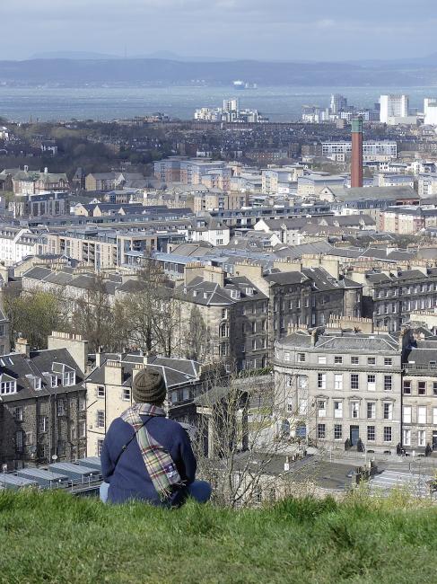 Woman sitting with a view over part of Spurtleshire.