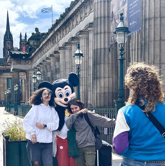 Tourists posing with fake Mickey Mouse by the RSA.