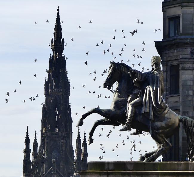 Steele's statue of Wellington in the foreground, the Scott Monument in the background, a flock of pigeons flying between the two. Photographed at lunchtime today.